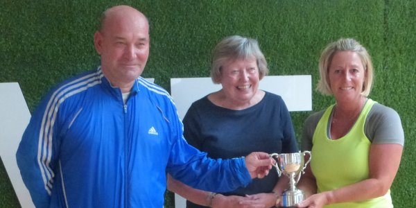 Winners Karl and Sue Dunn receive their trophy from, centre, Pippa Henshaw