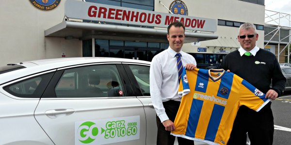 Shrewsbury Town’s Richard Hill with Steve Hughes, of Go Carz, at the Greenhous Meadow.