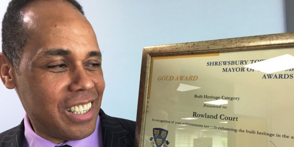 Sepp Sargeant, Head of Development, Housing Plus Group holding up the Mayor's Award