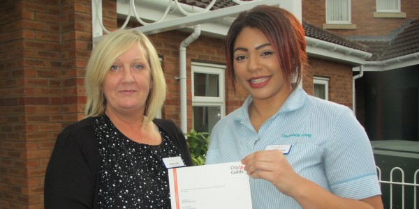 Former apprentice care assistant Mischa Marshall (right) celebrates her qualification with Debbie Ellis, Home Manager at Barclay Gardens