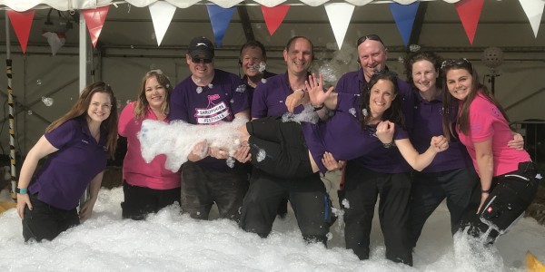 Shropshire Festivals team holding Beth Heath in foam party