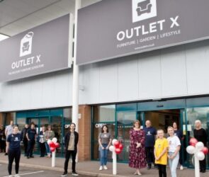 Liz Lowe, Head of Estates at Morris Property (centre in floral dress) with the Outlet X team and shoppers