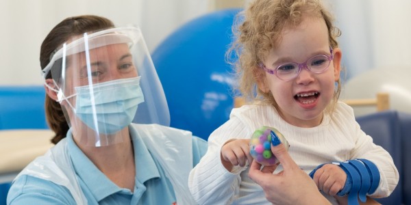 One of the first children back at The Movement Centre, Amelie, with Sarah Bew, Clinical Specialist Physiotherapist.