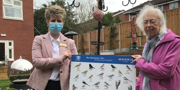 Radbrook Nursing Home General Manager, Jo Bennett and resident Sybil Williams with the bird feeders and identification boards donated by CJ Wildlife