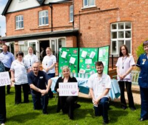 Carestaff gathered with smiles on their faces.