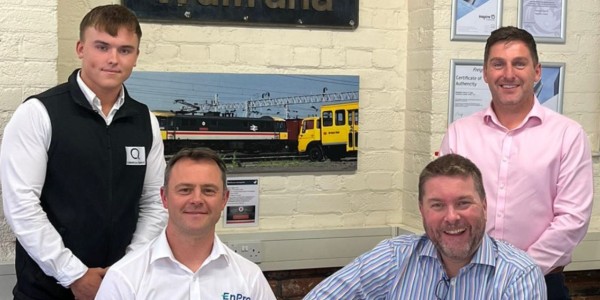 Group of four men from EnPro rail services stood with members of Q Financial Services