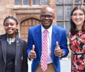 Athletics legend Kriss Akabusi with Adcote School Head Girls Mya Chogugudza, 12, and Eleni Higgins, 18.