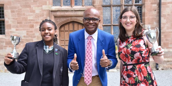 Athletics legend Kriss Akabusi with Adcote School Head Girls Mya Chogugudza, 12, and Eleni Higgins, 18.
