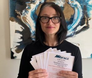 Angela Loughlin holding up leaflets for the event