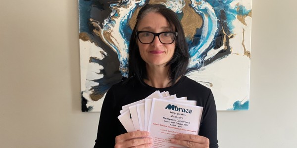 Angela Loughlin holding up leaflets for the event