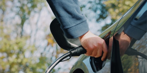 Man charging an EV at Fabweld.