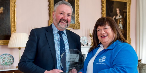 Colin Sweeney receives the award from Andrea Sammons