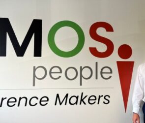 Stuart Danks in front of DMOS People sign